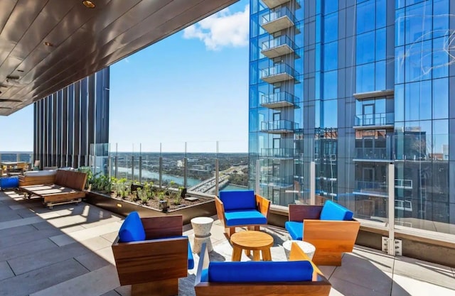 view of patio with a water view and an outdoor living space