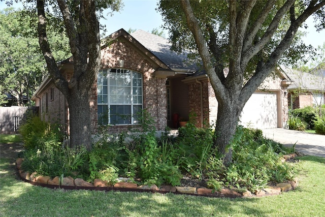 view of front of property with a garage and a front lawn