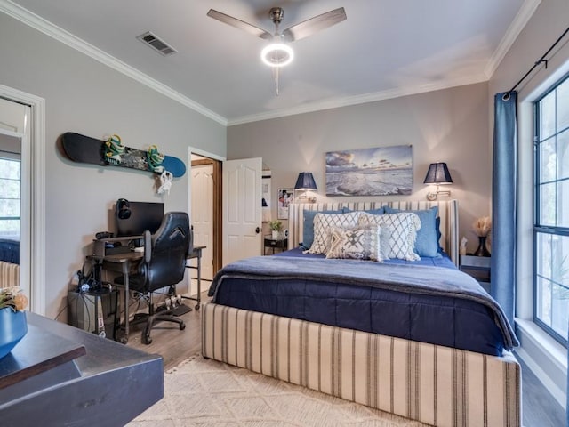 bedroom with ceiling fan, crown molding, and light wood-type flooring