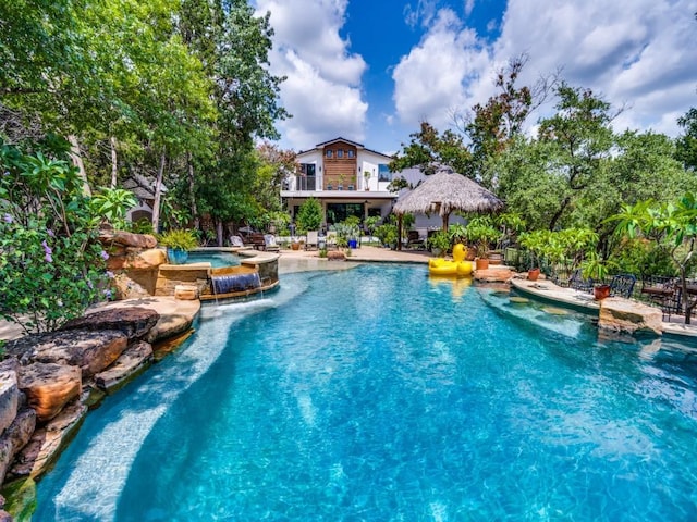 view of pool featuring pool water feature and a gazebo