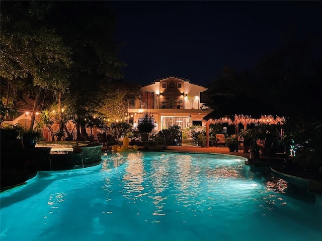 view of pool at night