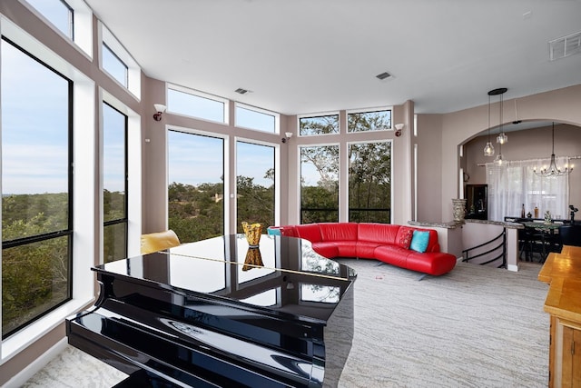 sunroom / solarium featuring a notable chandelier