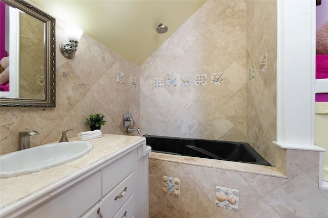 bathroom featuring vanity and tile walls