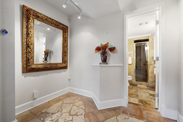 hallway featuring track lighting