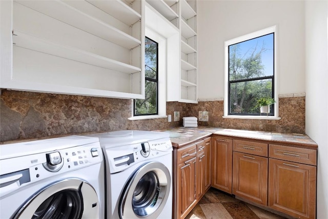 washroom featuring cabinets and independent washer and dryer