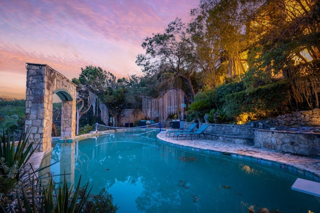 pool at dusk with a diving board