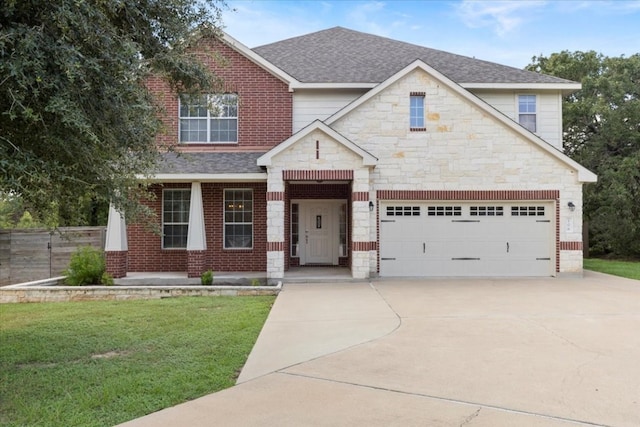 craftsman house with a front yard and a garage