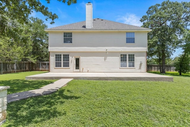 back of property featuring a patio area and a lawn