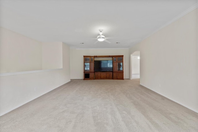 unfurnished living room featuring ceiling fan, light carpet, and crown molding