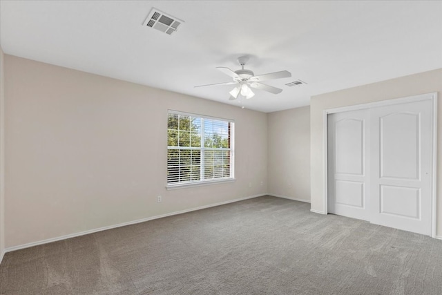 unfurnished bedroom with ceiling fan, a closet, and carpet floors