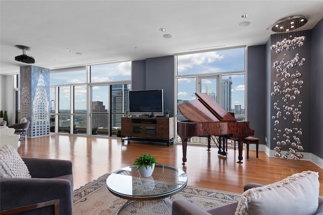 living room with expansive windows and light hardwood / wood-style flooring