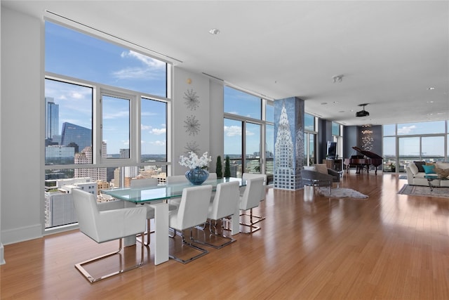 dining room featuring light hardwood / wood-style floors and floor to ceiling windows