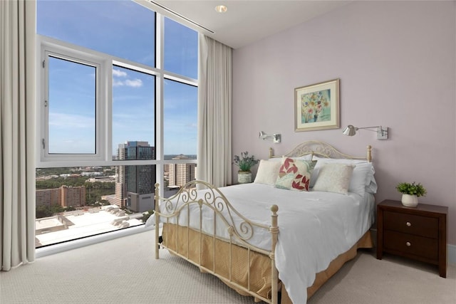 bedroom with expansive windows and carpet flooring
