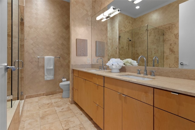 bathroom with vanity, toilet, ornamental molding, and an enclosed shower