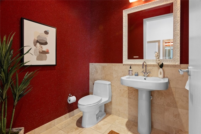 bathroom featuring tile walls, toilet, and tile patterned floors