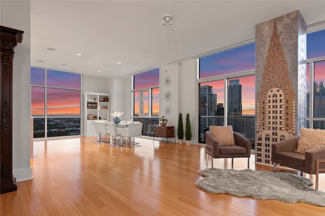 living room with light hardwood / wood-style flooring and floor to ceiling windows