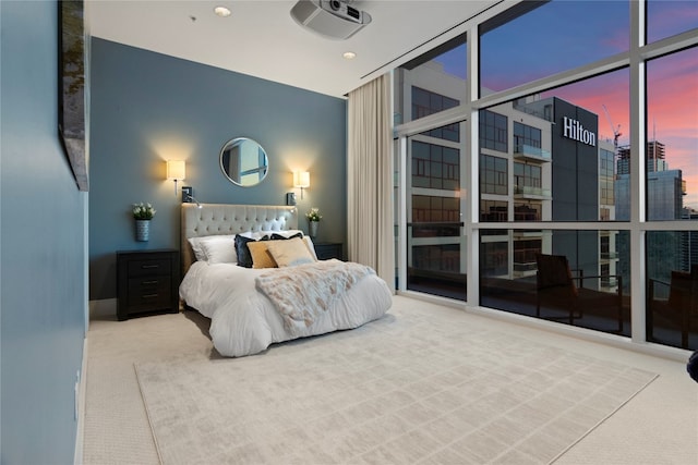 carpeted bedroom featuring floor to ceiling windows