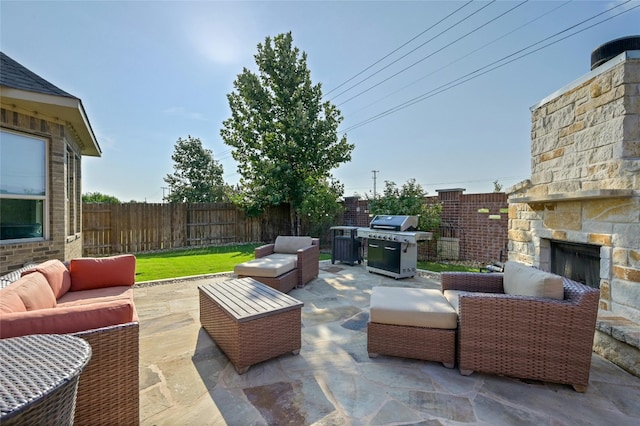 view of patio / terrace featuring an outdoor living space with a fireplace and area for grilling