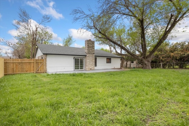 back of house with a lawn