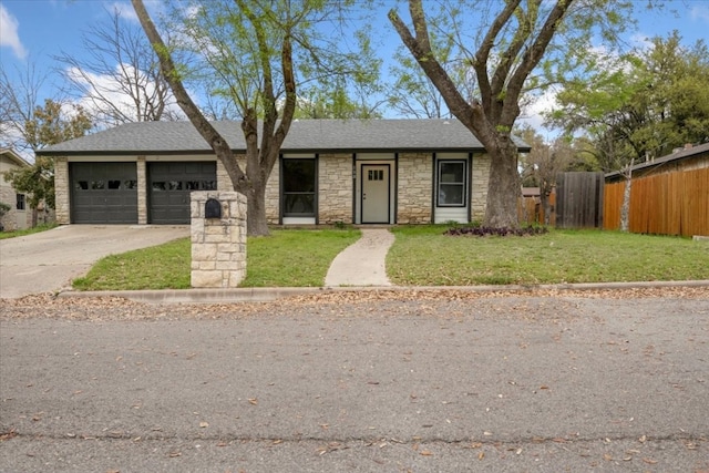 view of front of house with a front yard and a garage