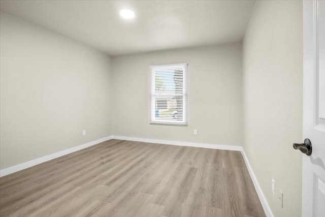 unfurnished room with wood-type flooring