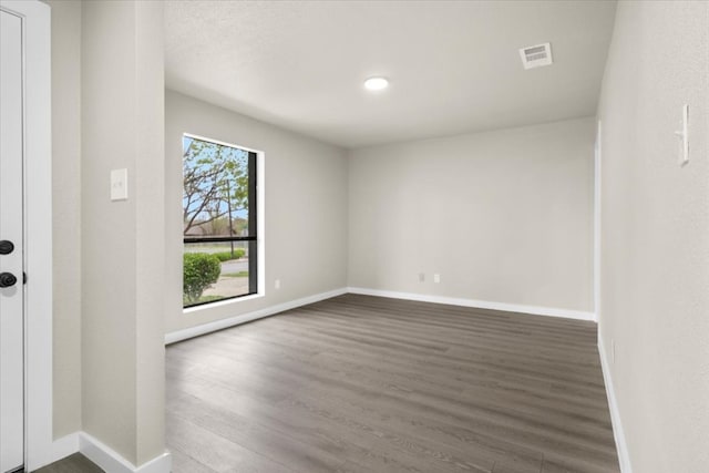 unfurnished room with wood-type flooring