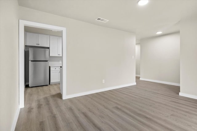 unfurnished living room featuring light hardwood / wood-style floors