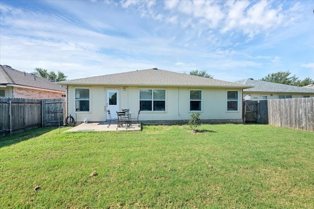 back of property featuring a lawn and a patio area