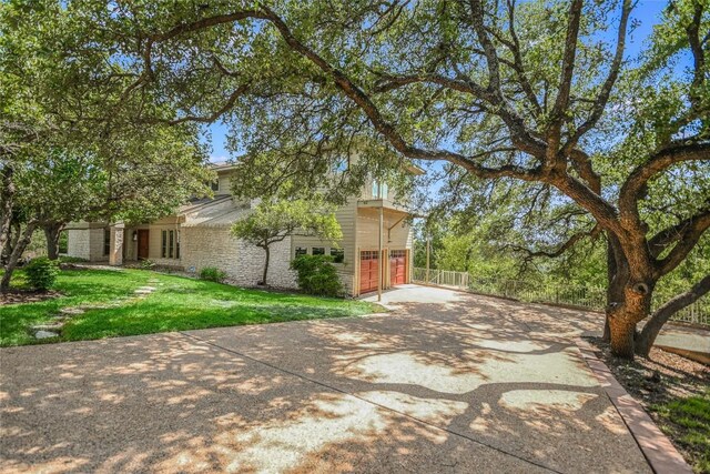 3 Hedge Ln, Austin, TX 78746 - view of side of property with a garage and a lawn