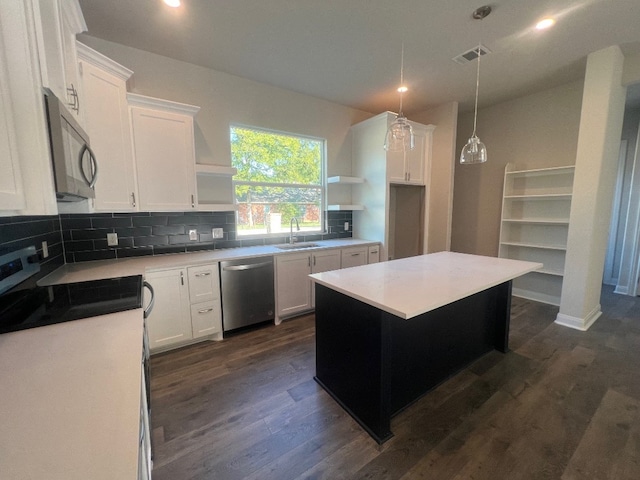 kitchen featuring decorative backsplash, sink, white cabinets, stainless steel appliances, and dark hardwood / wood-style flooring