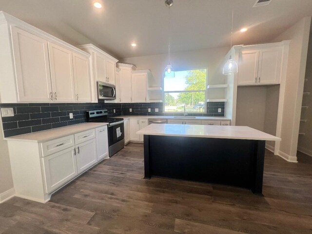 kitchen featuring appliances with stainless steel finishes, white cabinets, and dark hardwood / wood-style flooring