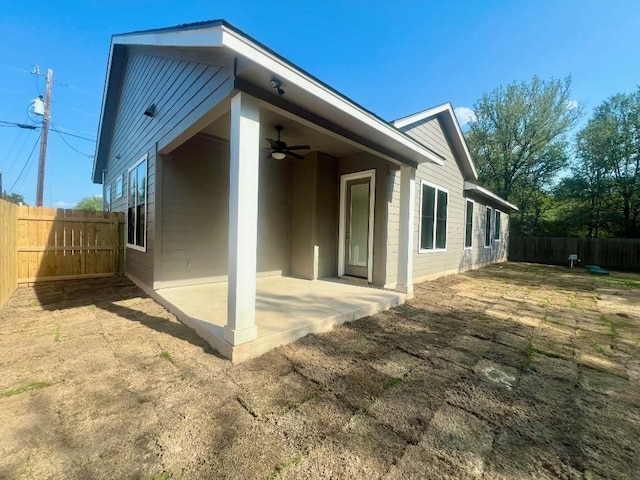 rear view of property featuring ceiling fan, a patio area, and a fenced backyard