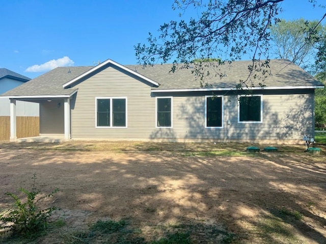 rear view of house featuring fence