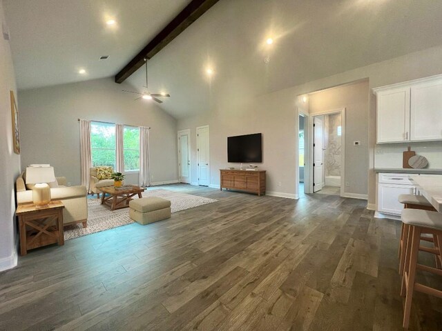 living room featuring beamed ceiling, wood-type flooring, high vaulted ceiling, and ceiling fan