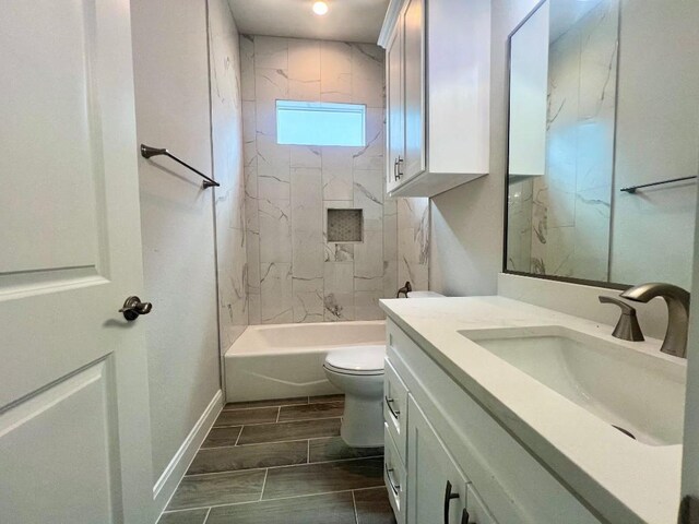 full bathroom with toilet, tile patterned floors, vanity, and tiled shower / bath