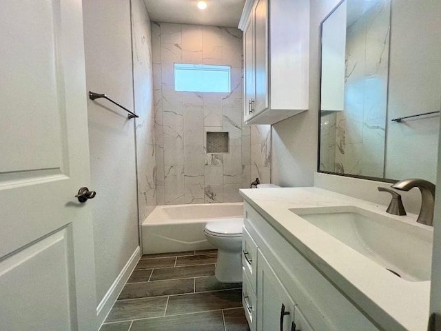 full bathroom featuring toilet, wood finish floors, vanity, baseboards, and  shower combination