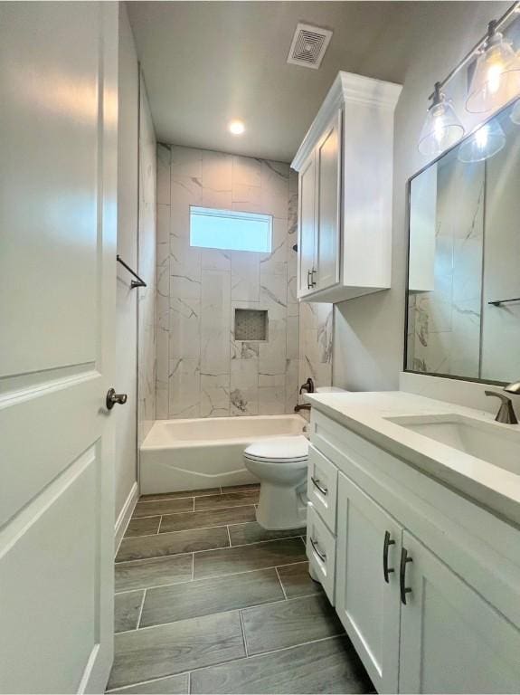 full bathroom with toilet, vanity, visible vents, tub / shower combination, and wood tiled floor