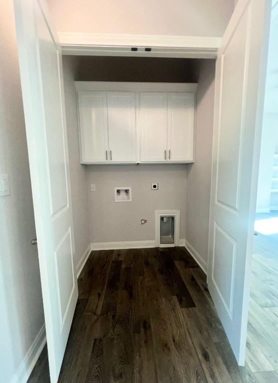 clothes washing area with hookup for a washing machine, cabinets, gas dryer hookup, and dark hardwood / wood-style flooring