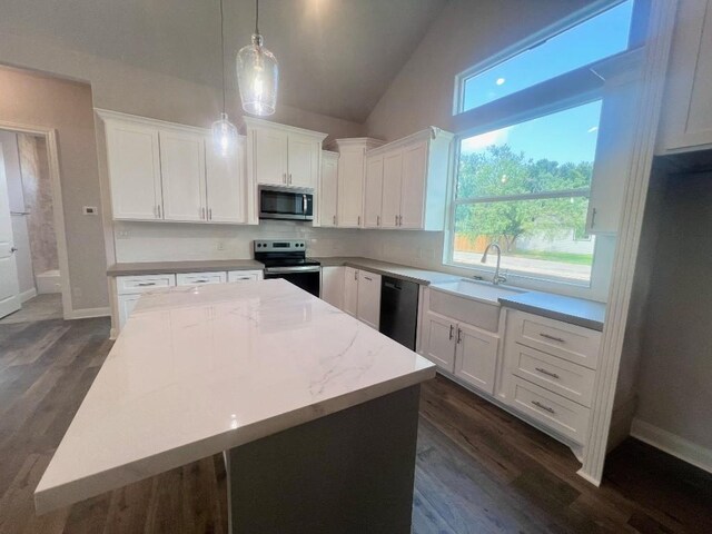 kitchen featuring a center island, dark hardwood / wood-style floors, white cabinets, hanging light fixtures, and appliances with stainless steel finishes