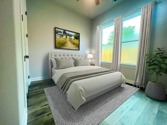 bedroom featuring ceiling fan, baseboards, and wood finished floors