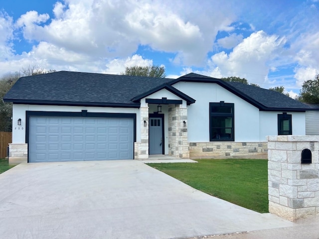 view of front of house featuring a garage and a front lawn