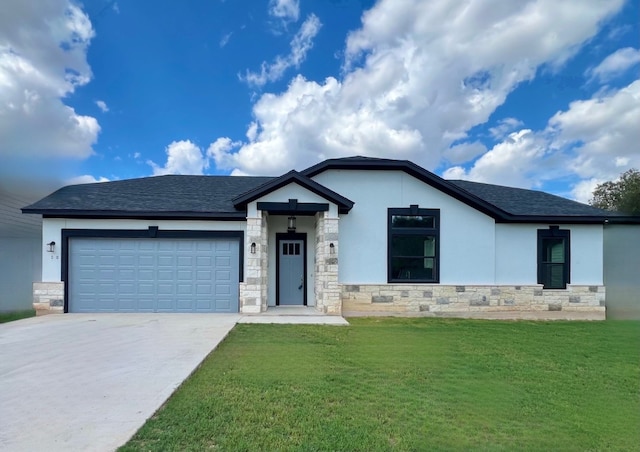 view of front of house with a garage and a front lawn