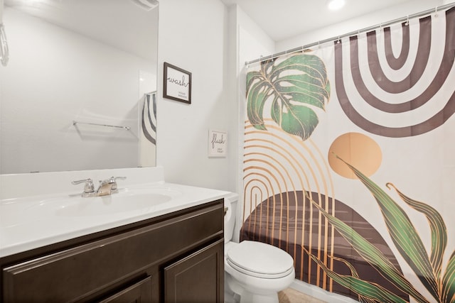 bathroom featuring vanity and toilet