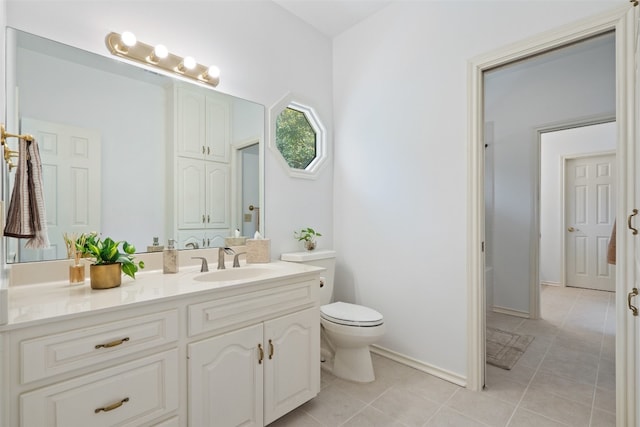 bathroom featuring vanity, toilet, and tile patterned flooring