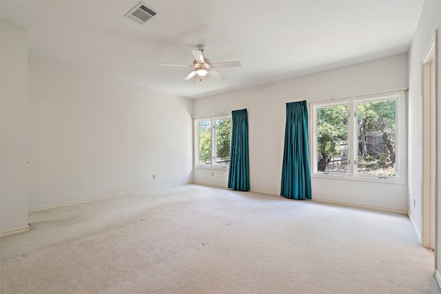 spare room with light colored carpet and ceiling fan