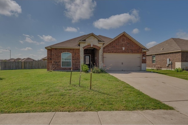 view of front of property featuring a front lawn and a garage