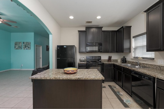 kitchen featuring black appliances, light tile patterned floors, a center island, ceiling fan, and sink