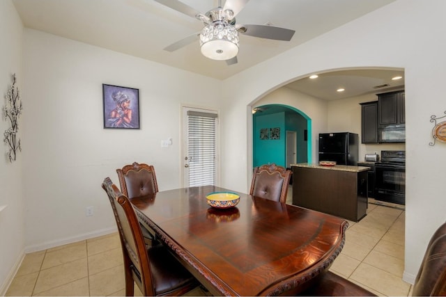 tiled dining room featuring ceiling fan