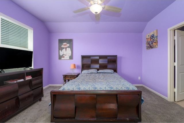 carpeted bedroom with ceiling fan and vaulted ceiling