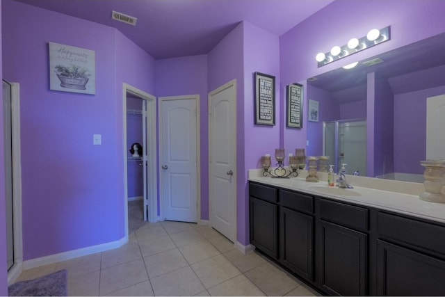 bathroom with an enclosed shower, tile patterned floors, and vanity